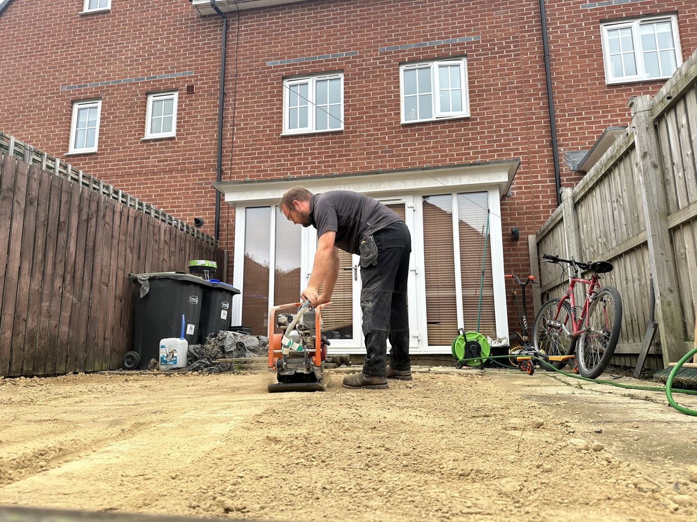 Nev compacting the sub-base across a whole back garden in front of the house