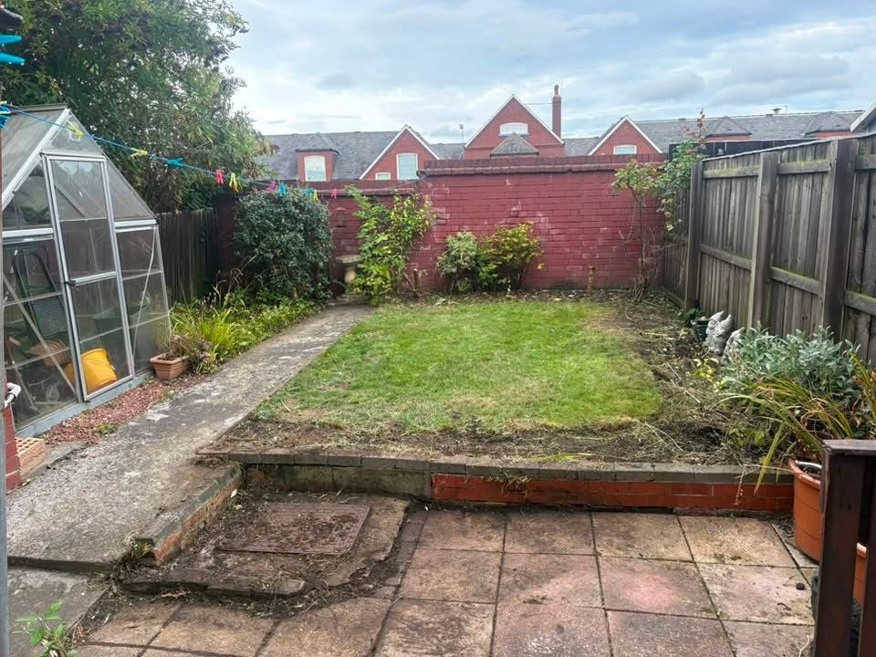 Finished terraced garden with lawn, greenhouse and path