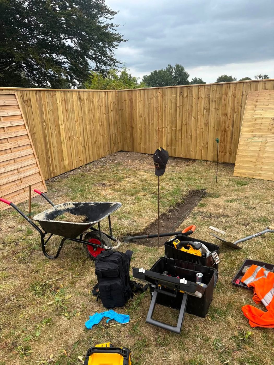 Pins and line marking out the base with tools on site